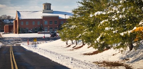 Ground with snow looking at Bob Evans hall in background