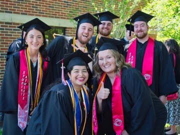 Rio graduates pose for picture with thumbs up