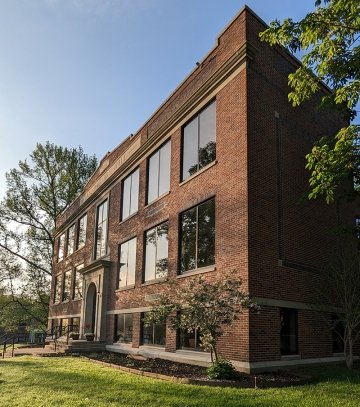 Sun reflects on the windows of Anniversary Hall home of the School of Education